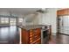 Open kitchen area with an island cooktop, hardwood floors, and stainless steel appliances at 1400 E Bethany Home Rd # 27, Phoenix, AZ 85014