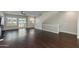 Living room with hardwood floors, staircase, and windows with white shutters at 1400 E Bethany Home Rd # 27, Phoenix, AZ 85014