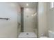 Modern shower with light tile, grey accent, glass surround and built-in bench at 1400 E Bethany Home Rd # 27, Phoenix, AZ 85014