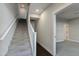 Carpeted staircase with a wooden railing, leading to the upper level at 1400 E Bethany Home Rd # 27, Phoenix, AZ 85014