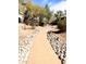 Scenic community walkway with rock landscaping, offering a tranquil outdoor experience at 14000 N 94Th St # 1224, Scottsdale, AZ 85260