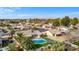 Aerial view of the property showcasing pool, turf, palm trees, and surrounding neighborhood at 1439 N Spencer --, Mesa, AZ 85203