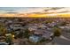 This aerial view captures the pool and backyard in a residential neighborhood at sunset at 1439 N Spencer --, Mesa, AZ 85203