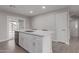 Well-lit kitchen island with a stainless steel dishwasher and a view to the outdoor living area at 15437 W Watson Ln, Surprise, AZ 85379