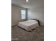 Neutral bedroom features carpet, a window with blinds, and a bed with an off-white comforter at 1602 W Central Ave, Coolidge, AZ 85128