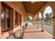 Exterior view of a building arcade featuring brick columns and wooden benches, ideal for relaxation at 1622 N 17Th Ave, Phoenix, AZ 85007