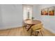 Bright dining area featuring a round wooden table with seating for two and desert themed wall art at 1622 N 17Th Ave, Phoenix, AZ 85007