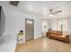 Bright living room featuring a leather sofa, wood floors, and a contemporary ceiling fan at 1622 N 17Th Ave, Phoenix, AZ 85007