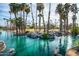 Scenic view of a serene lake with a cascading waterfall surrounded by lush palm trees and greenery at 1622 N 17Th Ave, Phoenix, AZ 85007