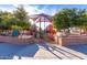 Bright playground with slides, climbers, and a sunshade, surrounded by trees and brick walls at 1622 N 17Th Ave, Phoenix, AZ 85007
