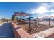 Outdoor playground with sunshade canopy, climbing structures, and secure fencing, perfect for recreation at 1622 N 17Th Ave, Phoenix, AZ 85007