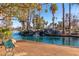 Picturesque water feature with cascading waterfalls, lush vegetation, and a charming park bench for relaxation at 1622 N 17Th Ave, Phoenix, AZ 85007