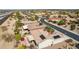 Residential aerial view of a home with solar panels, desert landscaping, and a covered patio, in a desert community at 17228 N Estrella Vista Dr, Surprise, AZ 85374