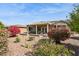 Expansive backyard with a covered patio, ideal for enjoying outdoor living amidst beautiful desert landscaping at 17228 N Estrella Vista Dr, Surprise, AZ 85374