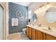 Bathroom featuring double sinks, decorative wall, vanity lighting and tiled flooring at 17228 N Estrella Vista Dr, Surprise, AZ 85374