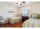 Bedroom featuring two twin beds, a window with shutters, and hardwood floors at 17228 N Estrella Vista Dr, Surprise, AZ 85374