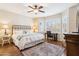 Cozy bedroom featuring a ceiling fan, plantation shutters, and stylish furnishings at 17228 N Estrella Vista Dr, Surprise, AZ 85374