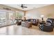 Inviting living room showcasing leather furniture, tile flooring, and a door to backyard at 17228 N Estrella Vista Dr, Surprise, AZ 85374