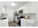 Contemporary kitchen with stainless steel appliances, white cabinetry, and stylish backsplash at 1942 S Emerson -- # 222, Mesa, AZ 85210