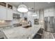 Bright kitchen featuring stainless steel appliances, white cabinetry, granite countertops, and a large island with barstool seating at 2027 W Calle De Las Estrella --, Phoenix, AZ 85085