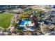 Aerial view of a community pool with a clubhouse, lounge chairs, and well-maintained landscaping at 2027 W Calle De Las Estrella --, Phoenix, AZ 85085