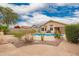 Desert landscaped backyard featuring pool, plants, and exterior home view at 20966 N 84Th Ln, Peoria, AZ 85382