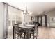 Bright dining area with white shutters and a view of the piano and backyard pool at 20966 N 84Th Ln, Peoria, AZ 85382