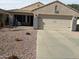 Charming home exterior with a two-car garage and tidy desert landscaping at 20966 N 84Th Ln, Peoria, AZ 85382