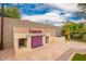 Backyard grill with built-in BBQ, stone accents, and desert plants at 20966 N 84Th Ln, Peoria, AZ 85382