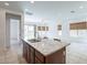 Kitchen island with granite countertop offers ample space and seating, connecting to a bright living area at 2117 E Oriole Dr, Gilbert, AZ 85297