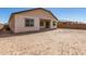 A view of a spacious backyard featuring a patio and block wall fence at 21960 E Saddle Ct, Queen Creek, AZ 85142