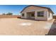 A view of a spacious backyard featuring a patio and block wall fence at 21960 E Saddle Ct, Queen Creek, AZ 85142