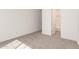 Clean bedroom showing carpet, a doorway to the bath, and neutral walls at 21960 E Saddle Ct, Queen Creek, AZ 85142