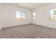 Spacious bedroom with multiple windows and neutral carpeting provides plenty of natural light at 21960 E Saddle Ct, Queen Creek, AZ 85142
