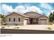 Charming single-story home with neutral stucco, brick accents, three windows, and a two car garage at 21960 E Saddle Ct, Queen Creek, AZ 85142