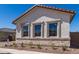 The front exterior features beautiful stone accents and desert landscaping at 21960 E Saddle Ct, Queen Creek, AZ 85142