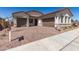 The front exterior features a brick paver driveway and three-car garage at 21960 E Saddle Ct, Queen Creek, AZ 85142