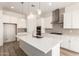 Bright kitchen with a large kitchen island, white countertops and cabinets, and stainless steel appliances at 21960 E Saddle Ct, Queen Creek, AZ 85142