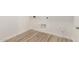 The laundry room features wood-look tile flooring and white walls at 21960 E Saddle Ct, Queen Creek, AZ 85142