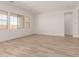 A spacious living room features wood-look tile flooring and large windows at 21960 E Saddle Ct, Queen Creek, AZ 85142