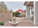 This backyard offers a fountain feature, desert landscaping, a red umbrella table set and rock accents at 22651 E Via Del Verde --, Queen Creek, AZ 85142