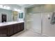 Main bathroom with double sinks, dark cabinets, and a walk-in shower at 22651 E Via Del Verde --, Queen Creek, AZ 85142