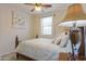 Cozy bedroom features ceiling fan, neutral walls, white window treatments and large painting at 22651 E Via Del Verde --, Queen Creek, AZ 85142