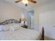 Comfortable bedroom features a ceiling fan, a bed with decorative pillows and direct access to an en-suite bathroom at 22651 E Via Del Verde --, Queen Creek, AZ 85142