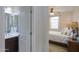 This bedroom features a window with white curtains and an attached bathroom with a sink, mirror and countertop at 22651 E Via Del Verde --, Queen Creek, AZ 85142