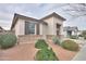 Exterior elevation of a home with drought-tolerant landscaping and a covered entryway at 22651 E Via Del Verde --, Queen Creek, AZ 85142