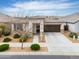 Home exterior showcases drought-tolerant landscaping, a wide driveway, and a covered entryway at 22651 E Via Del Verde --, Queen Creek, AZ 85142