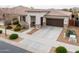 Charming home featuring a two-car garage, well-manicured landscaping, and a covered front porch at 22651 E Via Del Verde --, Queen Creek, AZ 85142