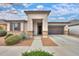 Inviting home featuring a two-car garage, neutral color palette, and low maintenance desert landscaping at 22651 E Via Del Verde --, Queen Creek, AZ 85142