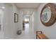 Long, bright hallway with tile flooring and neutral walls leading to the living areas of the home at 22651 E Via Del Verde --, Queen Creek, AZ 85142
